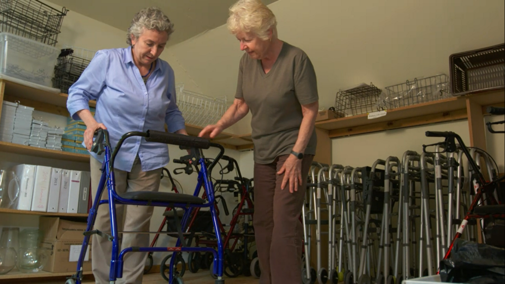 two woman looking at donated walker